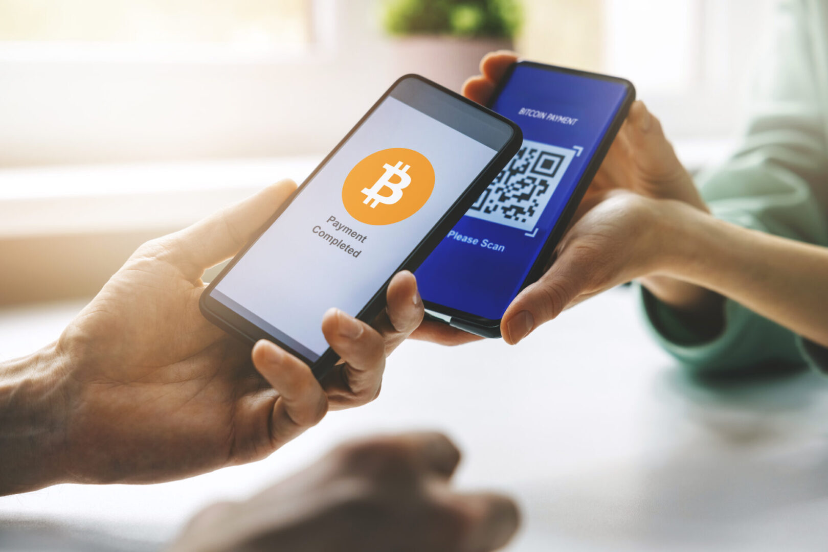 Person transferring Bitcoin via QR code on smartphone.