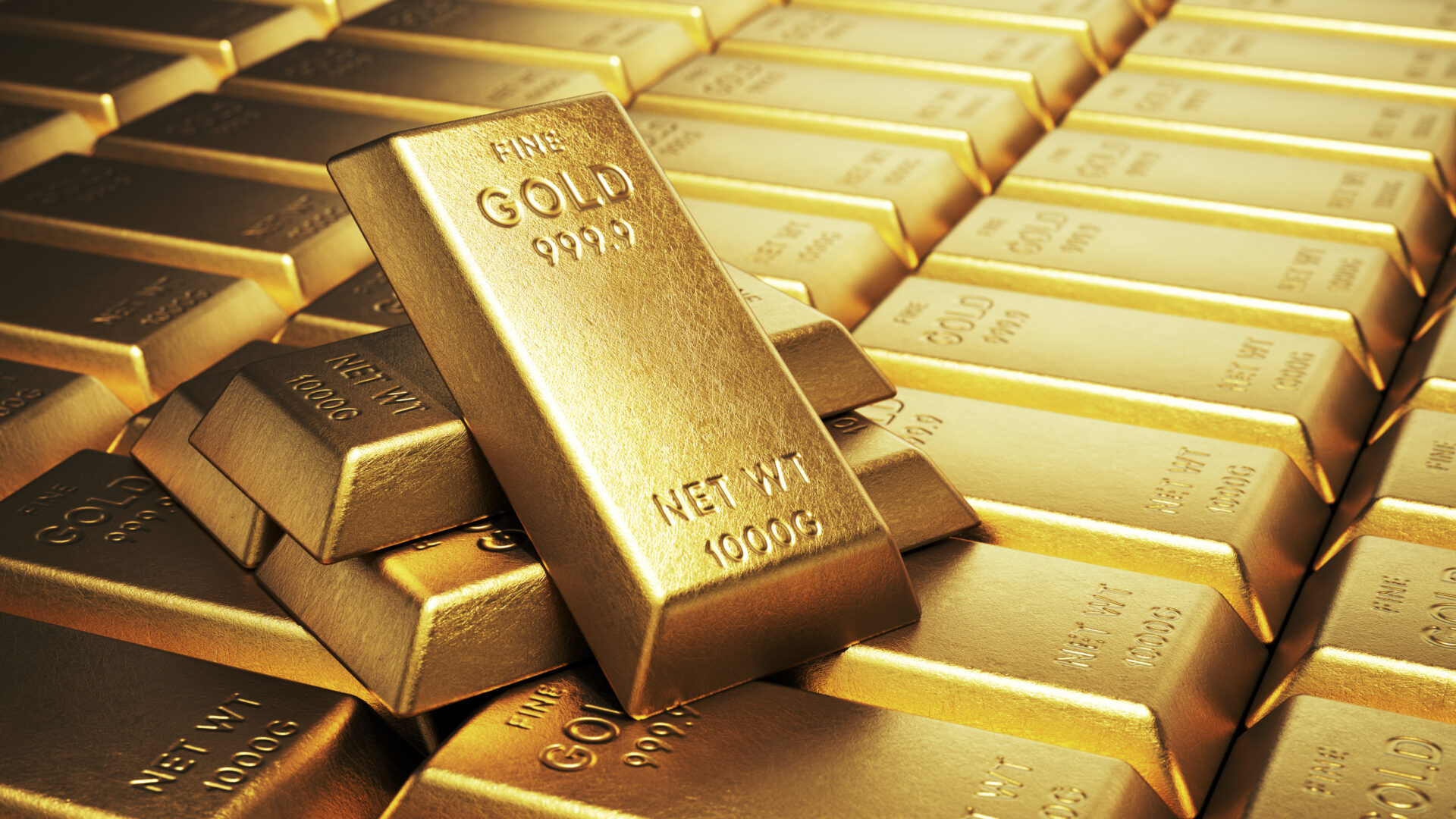 Stacks of shiny gold bars with 999.9 purity mark.