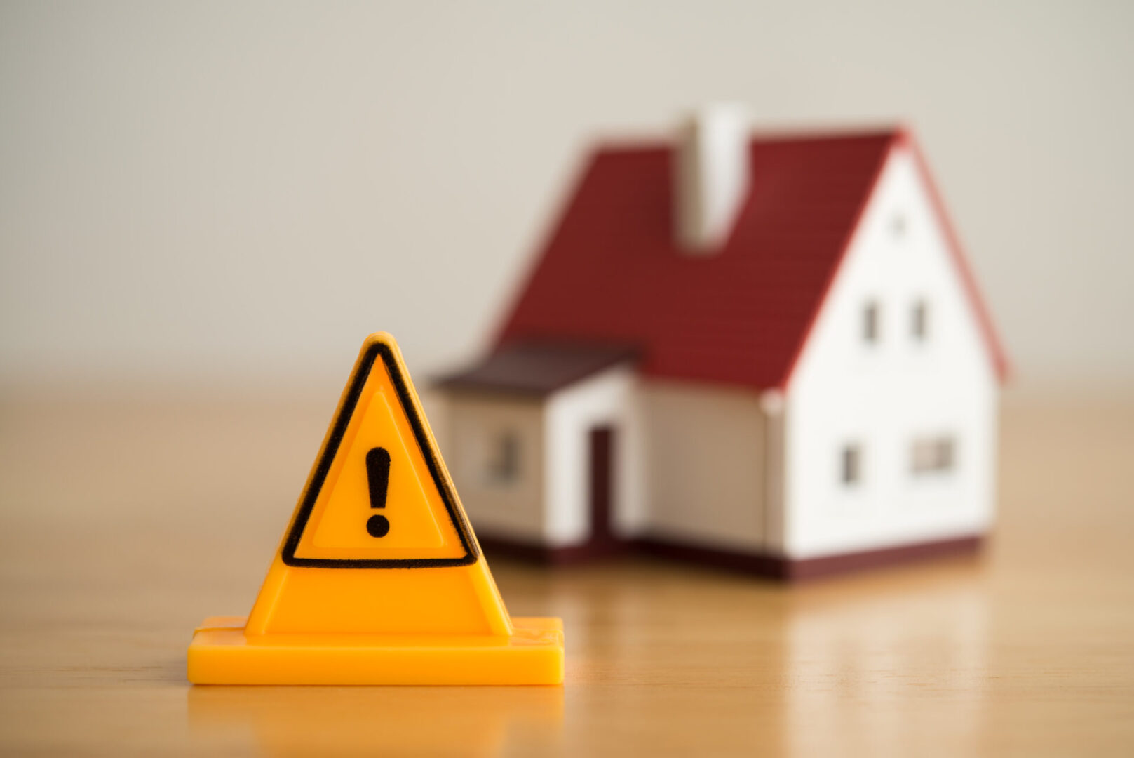 Warning sign in front of a model house.